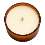 Candle in a brown container on a white background