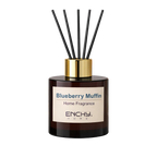 Home fragrance diffuser labeled 'Blueberry Muffin' by Enchy Home with black sticks on a light background.