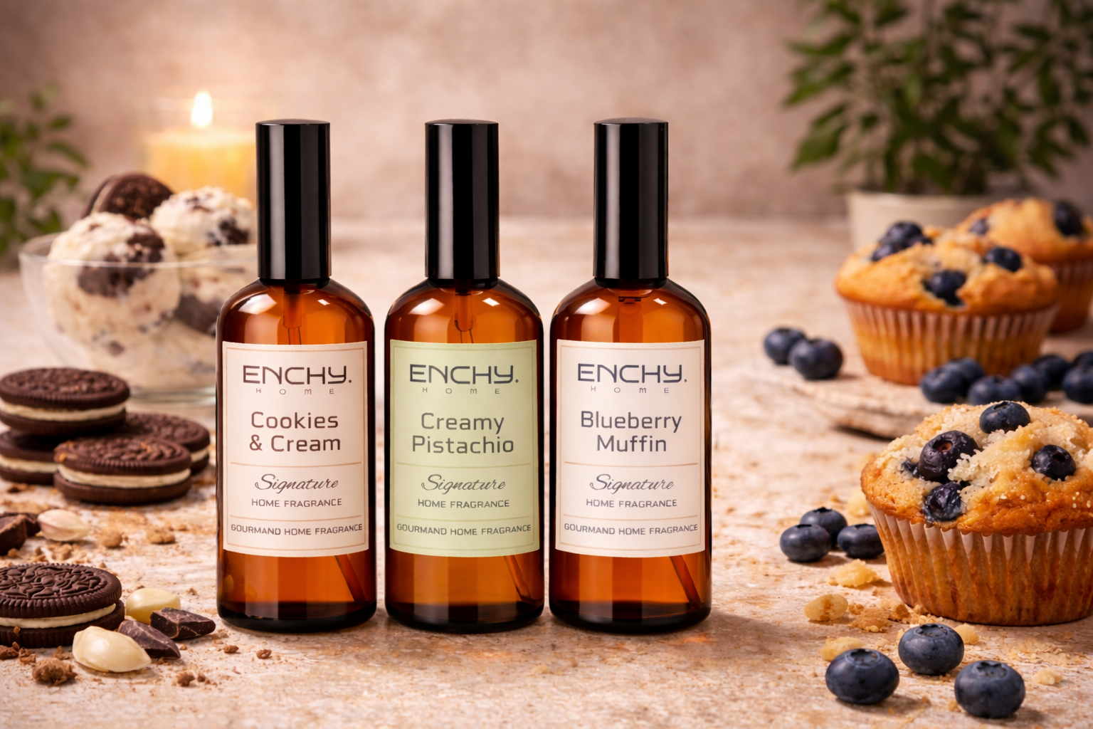 Three Enchy fragrance bottles with labels on a table with cookies, muffins, and blueberries.